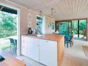 a kitchen with a sink and a table with chairs at 6 person holiday home in Fårevejle-By Traum in Fårevejle