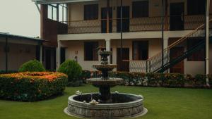 a fountain in a yard in front of a building at Hotel Austria in León