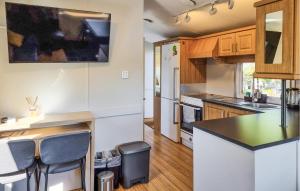 a kitchen with a counter and some chairs in it at Nice Ship In Göteborg With Sauna in Gothenburg