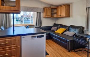 a living room with a couch and a kitchen at Nice Ship In Göteborg With Sauna in Gothenburg