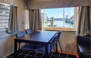 a dining room with a table and chairs and a window at Nice Ship In Göteborg With Sauna in Gothenburg +14 photos