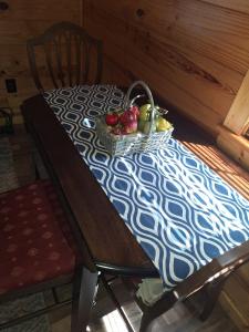 a table with a basket of fruit on it at Cozy Cabin near Dove Ridge Winery and Lake Weatherford in Azle +2 photos