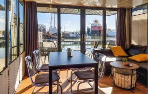 a balcony with a table and chairs and a view of a boat at Stunning Ship In Göteborg With Sauna in Gothenburg +9 photos