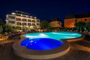 a large swimming pool at a resort at night at Atlant Hotel in St. St. Constantine and Helena