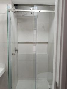 a shower with a glass door in a bathroom at HK5 Bed And Breakfast Apartment in Lima