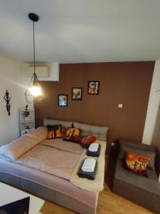 a bedroom with a large bed with pillows at Studio - Bee Happy in Sarajevo