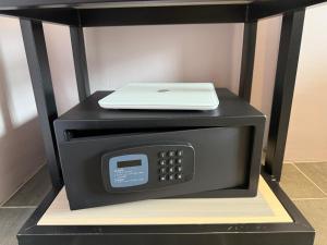 a microwave with a laptop on top of it at Q3 Inn in Semporna