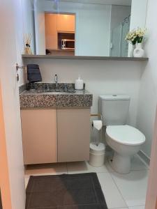 a bathroom with a toilet and a sink at Studio em São Paulo in Sao Paulo
