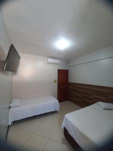 Ένα ή περισσότερα κρεβάτια σε δωμάτιο στο Hotel Akemi