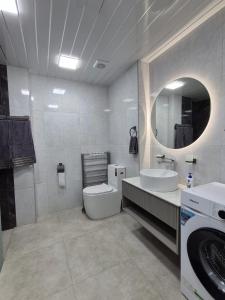 a bathroom with a toilet and a sink and a mirror at Alvina in Tsaghkadzor