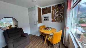 a living room with a table and a chair at Valle Sagrado in Coya