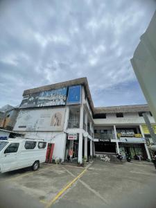 a white van parked in a parking lot in front of a building at Isa- Hostel in Panglao