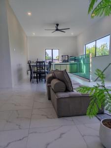 a living room with a couch and a table at 8ight Guesthouse 8号民宿 in Kluang