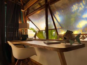 a room with a desk with a chair and a window at Fare Mãhanahana in Taoru