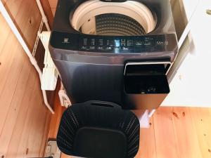 a washing machine is sitting in a room at Karin in Minami Aso +19 photos