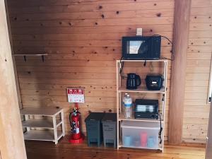 a room with a tv and a shelf with a microwave at Karin in Minami Aso +17 photos