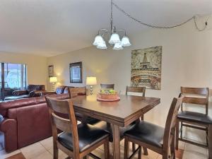 a dining room with a wooden table and chairs at Bay Oaks - E53 in Siesta Key +27 photos