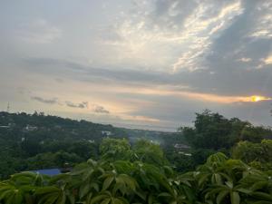 a view of a city from a hill with trees at Sky Haven Staycation in Rizal