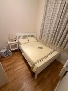 a bedroom with a white bed with a window at Dublin Cozy Room in Ballsbridge - near Grand Canal &Aviva in Dublin