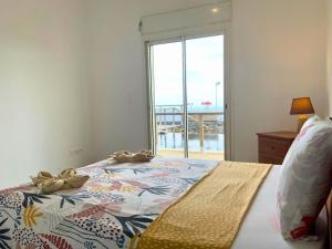a bedroom with a bed with a large window at Villa Aixa Le Lotus in Saint-Joseph +22 photos