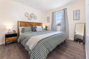 a bedroom with a large bed and a window at Renovated 2BR *Central Location* in Johnson City