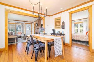 a dining room with a table and chairs and a bedroom at Remodeled 1920s Charmer Near ETSU, JCMC & Downtown in Johnson City