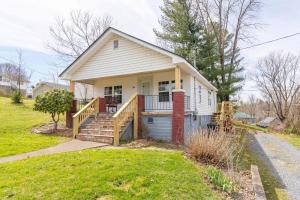 a small white house with a porch and stairs at Remodeled 1920s Charmer Near ETSU, JCMC & Downtown in Johnson City