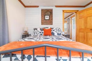 a bedroom with a bed with an orange pillow at Remodeled 1920s Charmer Near ETSU, JCMC & Downtown in Johnson City
