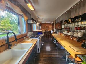 a kitchen with a sink and wooden counter tops at La Maison Conteneur in Amos