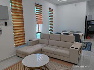 a living room with a couch and a table at Sri Midin Stay in Kuala Terengganu
