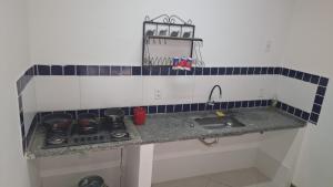 a kitchen counter with a stove and a sink at Casa Albatroz - primeira locaçao 4 suites in Búzios +21 photos