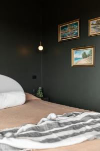 a bedroom with a bed and three pictures on the wall at Wherewithal Luxury Suites in Carlton +77 photos