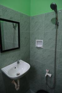 a bathroom with a sink and a shower at Sangi Tourist Inn near Kawasan Badian Canyoneering in Alegria