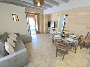a living room with a couch and a table at Maison de charme, terrasse ombragée près de Sarlat - FR-1-616-475 in Groléjac +9 photos