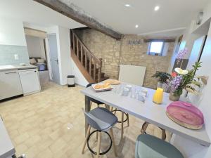 a kitchen and dining room with a table and chairs at Maison de charme, terrasse ombragée près de Sarlat - FR-1-616-475 in Groléjac
