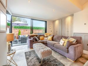 a living room with a couch and a table at Foreman's Cottage in Skidby