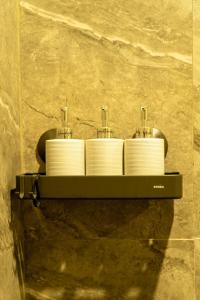 a shelf with four towels on a wall at Villa Samudra, Luxury and Comfort Villa by Balian Beach in Mantaak