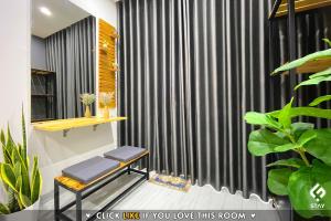 a bathroom with a black curtain and a bench at FSTAY - COZY AND PEACEFUL HOMESTAY DA NANG in Da Nang