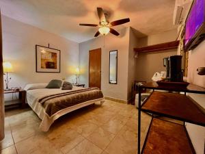 a bedroom with a bed and a ceiling fan at Hotel 305 in Parras de la Fuente