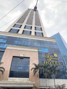 a tall building with a hotel sign on it at Exquisite Stays Private 2BR Rental in Manila