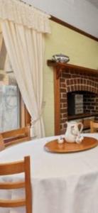 a toy dog sitting on a table in front of a fireplace at Aeris Country Cottage in Junee