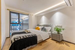 Postel nebo postele na pokoji v ubytování Duoya International Apartment