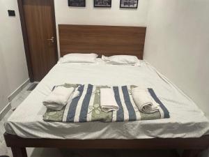 a bed with two towels on top of it at a28 ORANGE BRICKS - Park Street - New Market in Kolkata