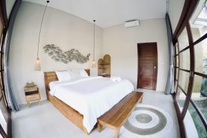 a bedroom with a swinging bed and a window at YuraAmed Villa in Amed +19 photos