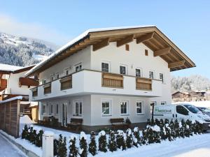a large white building with snow in front of it at Apartment in Aschau near Ski Slopes in Aschau