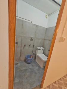 a bathroom with a toilet and a shower at Tribano vattavada in Vattavada