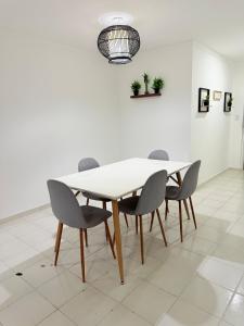 a dining room with a white table and chairs at Hermoso apartamento en Calle 50 Panama in Panama City