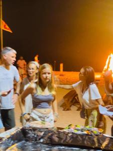 a group of people standing around a table at NN Beach Resort Nilaveli in Nilaveli