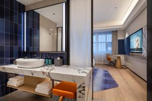 a bathroom with a sink and a large mirror at Novotel Shanghai Hongqiao International Airport in Shanghai +34 photos