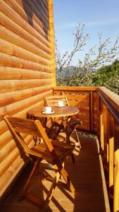 a wooden table and chairs on a wooden deck at Hiška sprostitve in Vransko